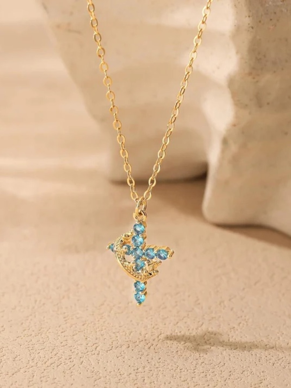 Gold-Tone Cross Pendant Necklace with Blue Crystal Accents